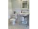 Classic bathroom with stylish fixtures, white wainscoting, and black and white tile floor at 112 Hilton Ave, Durham, NC 27707