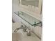 Detailed view of a sink and glass shelf, featuring vintage-style faucet and classic design elements at 112 Hilton Ave, Durham, NC 27707