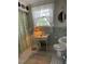 Cozy bathroom with floral accents, patterned curtain, and vintage decor at 112 Hilton Ave, Durham, NC 27707