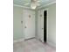 This bedroom features an open closet, unique checkered floors, and white doors decorated with floral art at 112 Hilton Ave, Durham, NC 27707