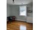 A bedroom with wood floors, a white bookcase, and a desk and chair at 112 Hilton Ave, Durham, NC 27707