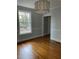 Bright dining room with large window, wood floors, and stylish lighting fixture at 112 Hilton Ave, Durham, NC 27707