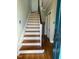 View of hardwood entry stairs with the front door open at 112 Hilton Ave, Durham, NC 27707