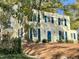 Exterior view of charming two-story home with mature trees and landscaping at 112 Hilton Ave, Durham, NC 27707