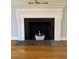 Fireplace with white mantel and hearth featuring decorative basket at 112 Hilton Ave, Durham, NC 27707