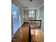 Upstairs landing with hardwood floors and a view to another room, bathed in natural light at 112 Hilton Ave, Durham, NC 27707