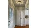 Inviting hallway with wooden floors and a unique vintage ceiling light fixture at 112 Hilton Ave, Durham, NC 27707