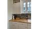 Kitchen featuring butcher block counters, white cabinetry, and mosaic tile backsplash at 112 Hilton Ave, Durham, NC 27707