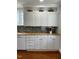 Bright kitchen featuring butcher block counters, white cabinetry, and stainless steel appliances at 112 Hilton Ave, Durham, NC 27707