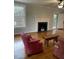 Living room with decorative fireplace, hardwood floors, and furniture at 112 Hilton Ave, Durham, NC 27707