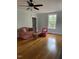Living room features hardwood floors, large windows, and ceiling fan at 112 Hilton Ave, Durham, NC 27707