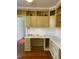 Bright office space with a built-in desk, storage, and warm wood flooring at 112 Hilton Ave, Durham, NC 27707