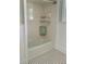 A shower with white walls and black and white tile flooring at 112 Hilton Ave, Durham, NC 27707
