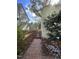 A brick walkway leads through the side yard, bordered by wood fencing and mature plantings at 112 Hilton Ave, Durham, NC 27707