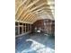 Large unfinished storage area with wood rafters and a gravel floor at 112 Hilton Ave, Durham, NC 27707