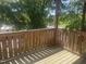 Deck with wood railing, with green trees visible in the background at 113 Conner Dr # 203, Chapel Hill, NC 27514
