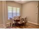 Cozy dining area with hardwood floors and a window providing natural light at 113 Conner Dr # 203, Chapel Hill, NC 27514