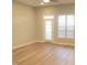 Bright and spacious living room with hardwood floors and a door to the outside at 113 Conner Dr # 203, Chapel Hill, NC 27514