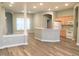 Open-concept living room and kitchen area featuring new floors and fresh paint at 113 Conner Dr # 203, Chapel Hill, NC 27514