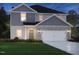Charming home exterior featuring a gray siding, stone accents, and a two-car garage at 1139 Winding Spring Dr, Mebane, NC 27302