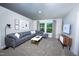 Relaxing living room with comfortable gray sectional sofa, modern coffee table, and bright natural light from large windows at 1139 Winding Spring Dr, Mebane, NC 27302