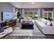 Spacious living room featuring large windows, stylish furniture, and a modern rug at 1139 Winding Spring Dr, Mebane, NC 27302