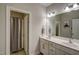 Well-lit bathroom with double vanity, white cabinets and a shower with curtain at 124 Shale Creek Dr, Durham, NC 27703