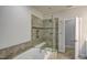The primary bathroom features a large soaking tub and shower with tile surround and a glass door at 124 Shale Creek Dr, Durham, NC 27703