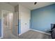 Bedroom with neutral carpet and two-tone blue walls, featuring two closets and hall access at 124 Shale Creek Dr, Durham, NC 27703