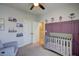 View of the Bedroom featuring a crib and purple accent wall with flower decorations at 124 Shale Creek Dr, Durham, NC 27703