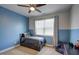 Cozy bedroom with two-tone walls, a ceiling fan, and a bright window at 124 Shale Creek Dr, Durham, NC 27703