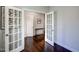 Bonus room featuring hardwood floors, a French door, and a standard door leading to other rooms of the home at 124 Shale Creek Dr, Durham, NC 27703