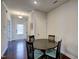 Dining area featuring wood floors, neutral walls, and views of the entryway and the front door at 124 Shale Creek Dr, Durham, NC 27703