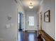 Bright hallway with white trim, wood floors, and neutral walls leading to other rooms in the home at 124 Shale Creek Dr, Durham, NC 27703