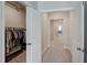 Hallway with an open closet with shelving and hanging clothes at 124 Shale Creek Dr, Durham, NC 27703