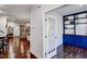 Hallway view that flows into the living room, showcasing hardwood floors and a bonus room with custom shelving at 124 Shale Creek Dr, Durham, NC 27703
