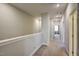 Upstairs hallway featuring neutral carpet, a white railing, and natural light at 124 Shale Creek Dr, Durham, NC 27703