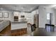 The modern kitchen is complete with stainless steel appliances, white cabinets, and a granite island with sink at 124 Shale Creek Dr, Durham, NC 27703