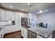 The modern kitchen island is complete with granite countertops, stainless steel appliances, and an open floor plan at 124 Shale Creek Dr, Durham, NC 27703