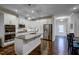 The modern kitchen is complete with stainless steel appliances, white cabinets, and a granite island with sink at 124 Shale Creek Dr, Durham, NC 27703