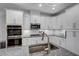 Bright kitchen with stainless steel appliances, granite countertops, and ample white cabinets at 124 Shale Creek Dr, Durham, NC 27703