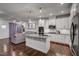 Open-concept kitchen features an island, granite countertops, stainless appliances, and easy access to the living area at 124 Shale Creek Dr, Durham, NC 27703