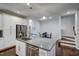 The modern kitchen island is complete with granite countertops, stainless steel appliances, and an open floor plan at 124 Shale Creek Dr, Durham, NC 27703