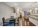 Open concept living space with hardwood floors featuring a dining table, living room, staircase, and kitchen at 124 Shale Creek Dr, Durham, NC 27703