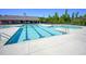 Community pool featuring a large swimming area with lane markers, a spa, and a covered lounge area with ample seating at 124 Shale Creek Dr, Durham, NC 27703