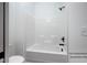 Bathroom tub with shower and white tiles at 12845 Mallard Rock Rd, Zebulon, NC 27597