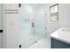 Walk-in shower with glass door, seat, and large white tiles at 12845 Mallard Rock Rd, Zebulon, NC 27597