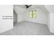 Bright bedroom showcasing a vaulted ceiling, neutral walls, gray carpet, and large window at 12845 Mallard Rock Rd, Zebulon, NC 27597