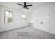 Bright bedroom featuring neutral walls, gray carpet, and a modern ceiling fan at 12845 Mallard Rock Rd, Zebulon, NC 27597