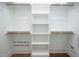 White closet with built-in shelving and wooden closet rods at 12845 Mallard Rock Rd, Zebulon, NC 27597